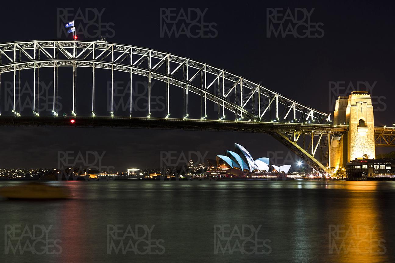 Iconic view of the Sydney Harbour Bridge and Sydney Opera House. Image taken at night using the long exposure technique