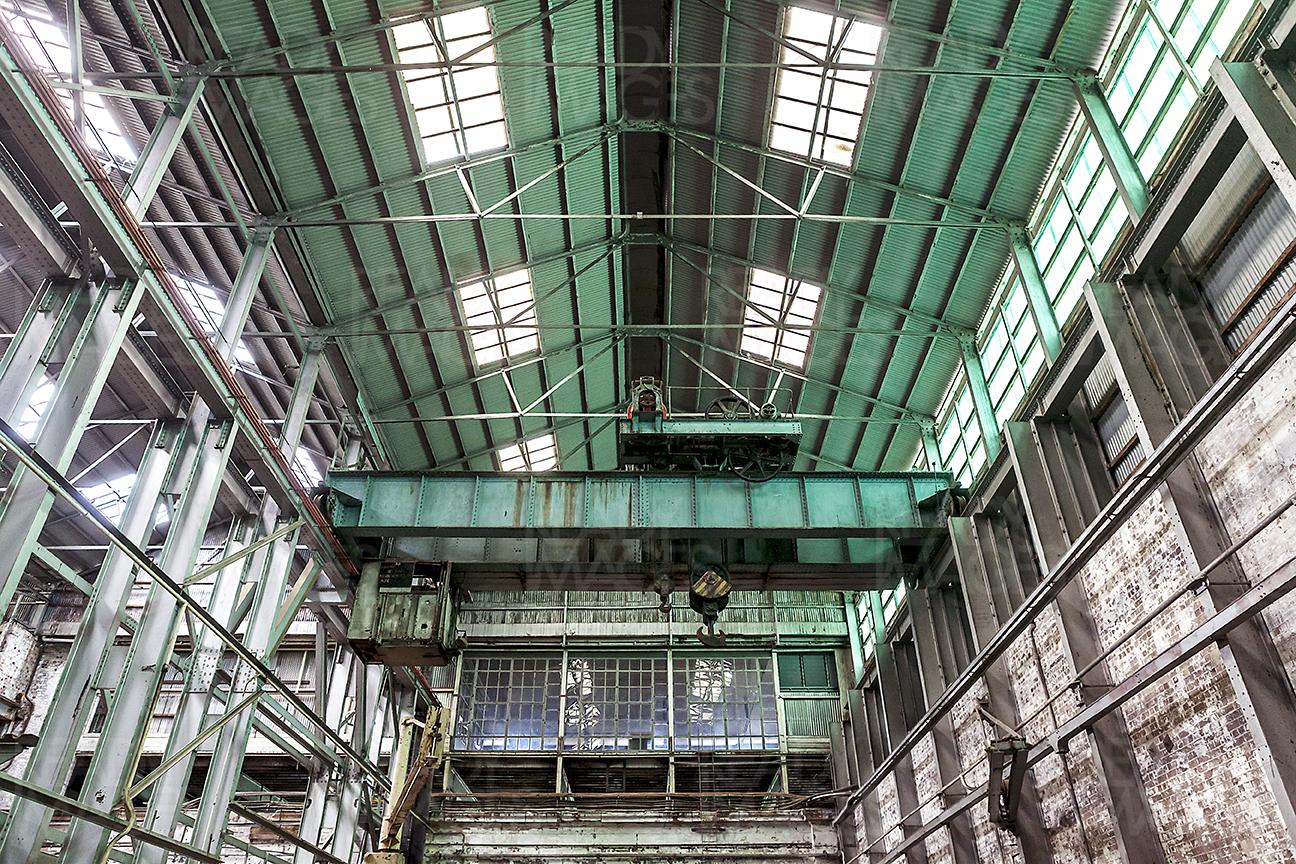 Image of an old building in industrial design precinct looking up showing metal cladding, roof, skylight and steel structure at Cockatoo Island, Sydney, Australia