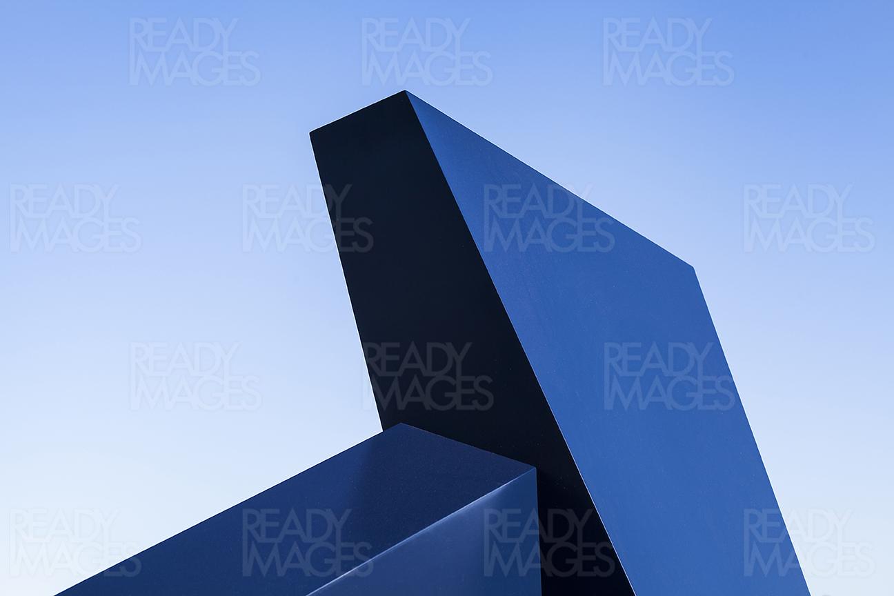 Close-up abstract image of a smooth shiny blue painted structure