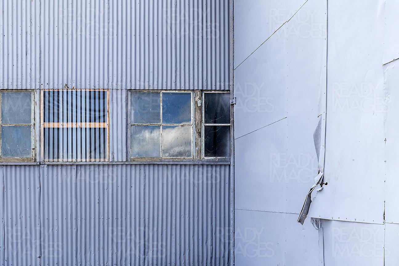 Abstract image of the rustic corrugated metal sheets and old glass windows