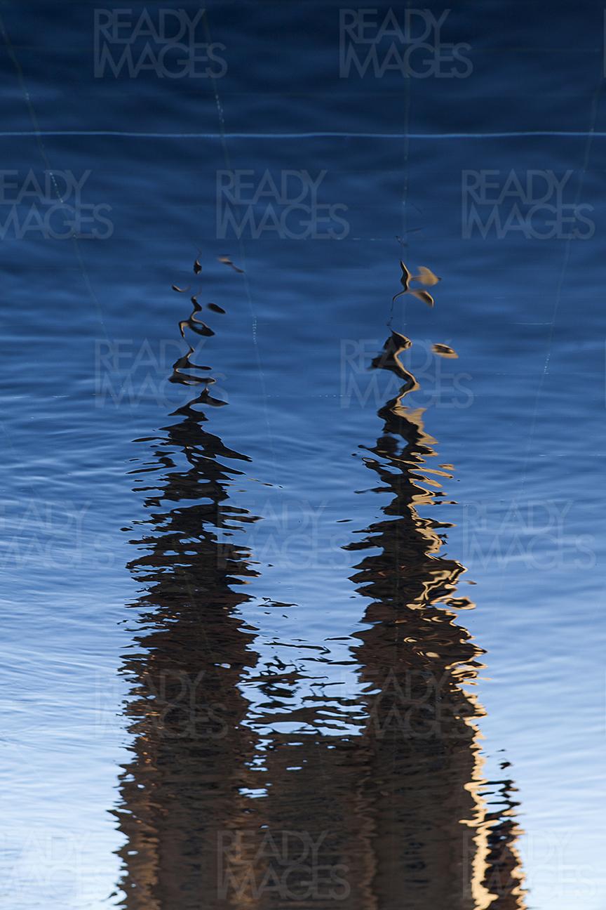 Abstract image of a soft blue rippled water with reflection of St Mary's Cathedral, Sydney, Australia