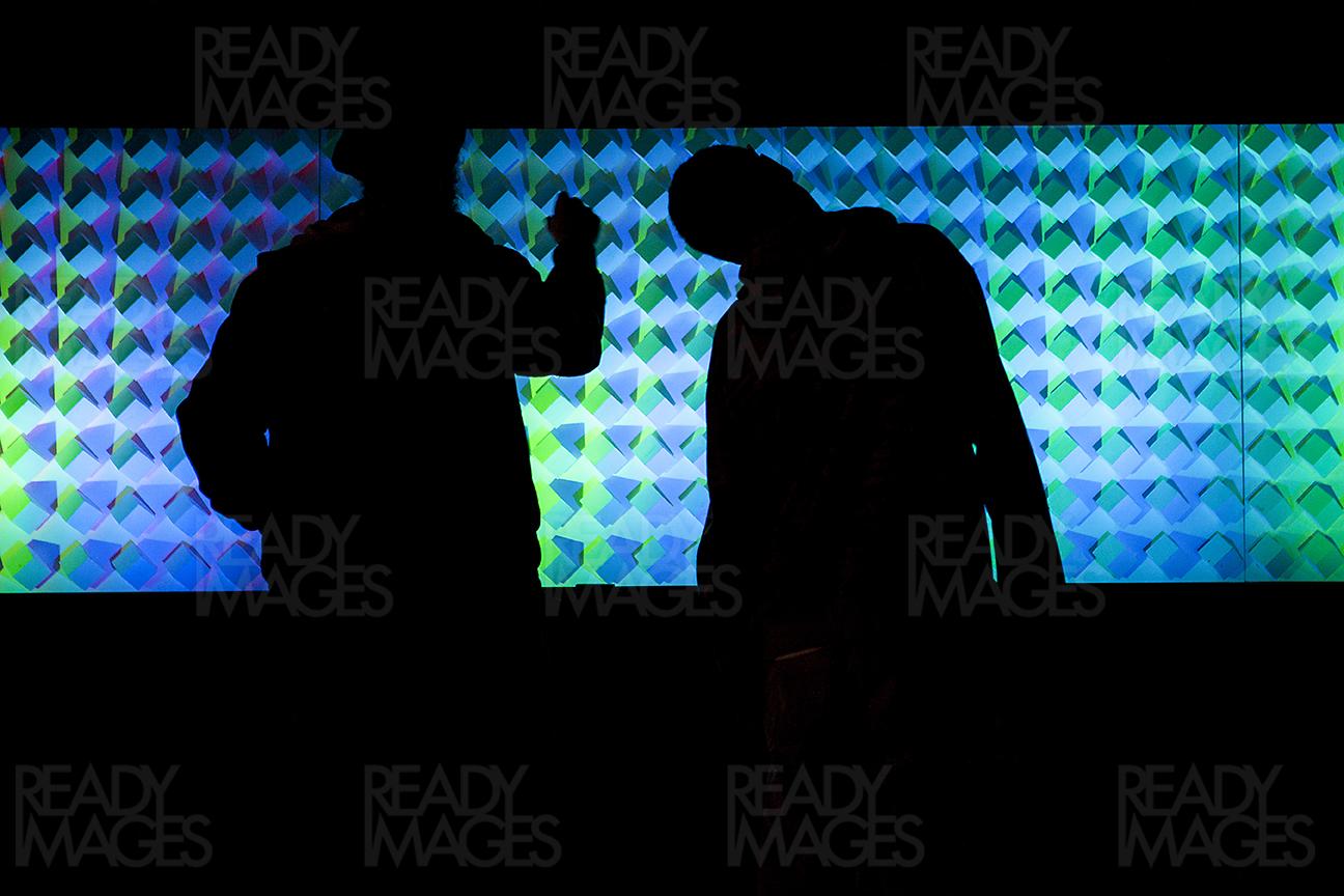 Shadow of 2 people looking at a light installation at Vivid Sydney Light Festival