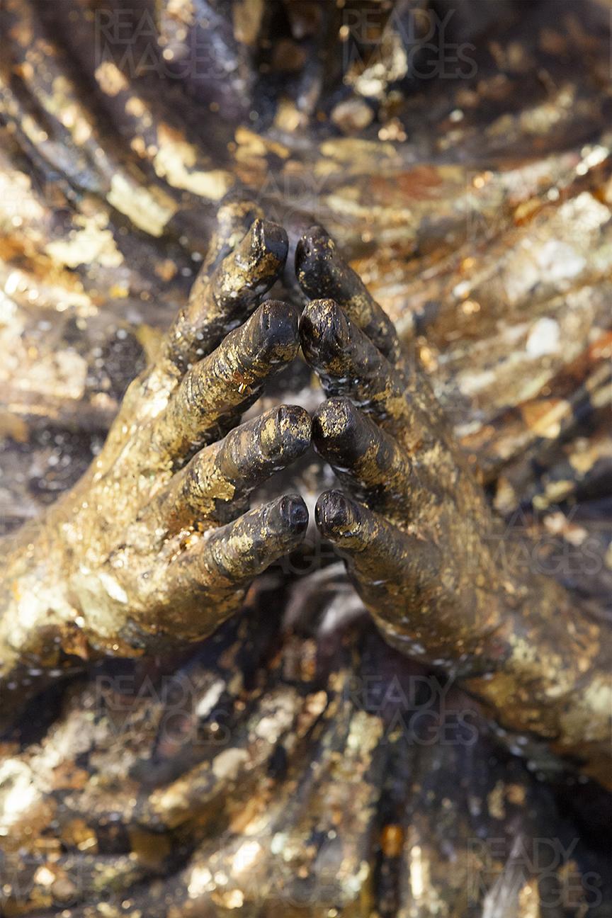 Close-up image of the hands of a statue from a Buddhist Temple in Bangkok