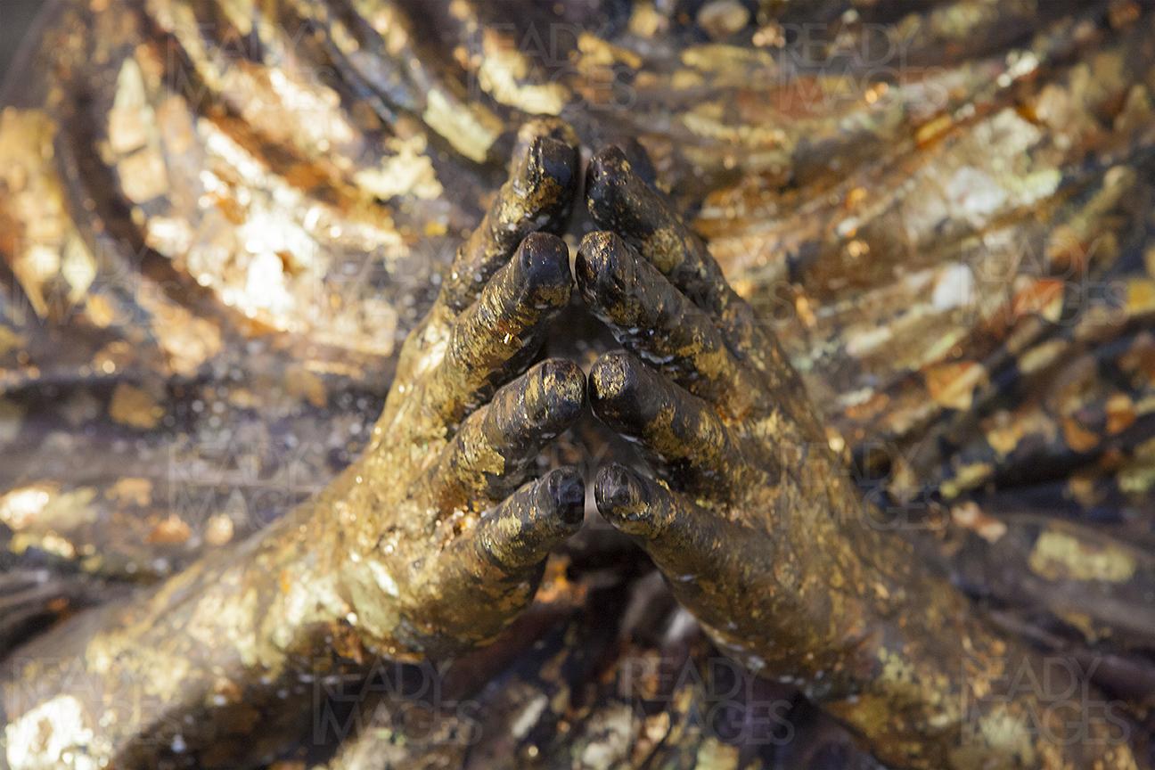Close-up image of the hands of a statue from a Buddhist Temple in Bangkok