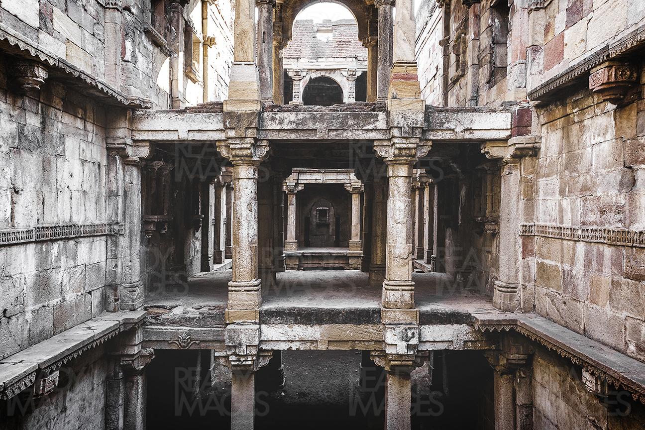 Symmetrical image of Jethabhai Stepwell looking at series of an arched colonnade, Ahmedabad, India