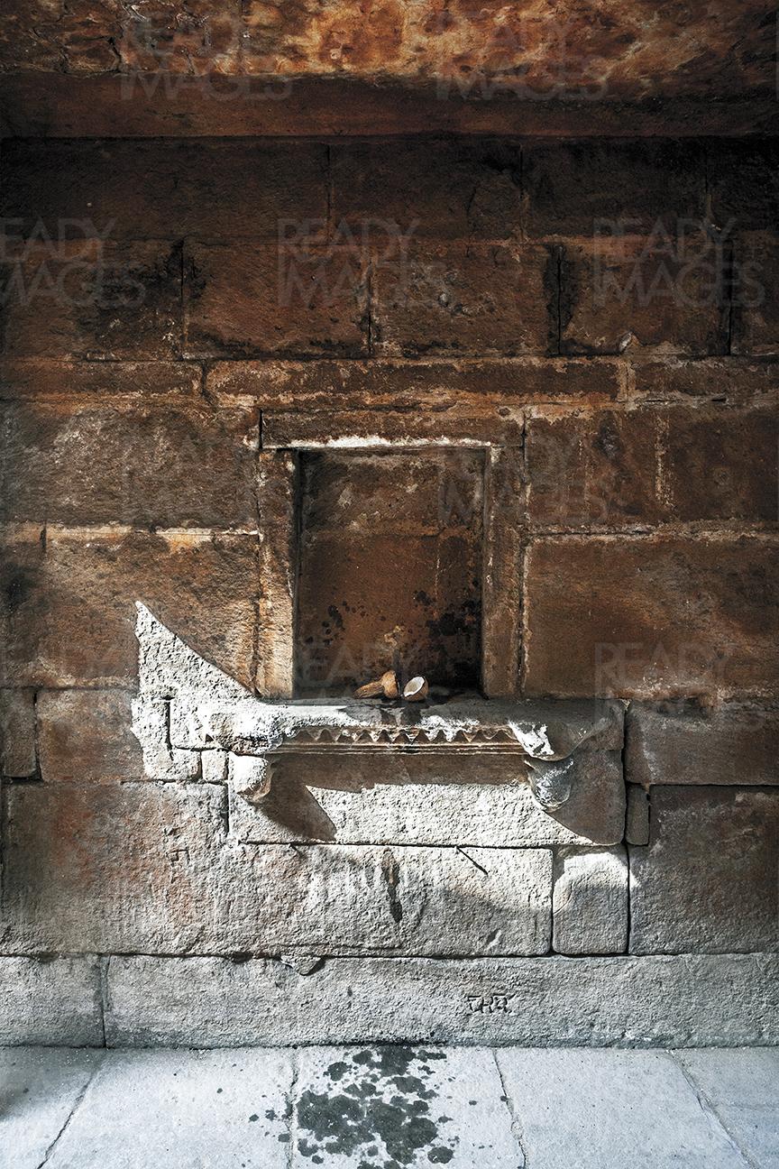 Vertical grungy image of a sidewall of the stepwell - worship niche