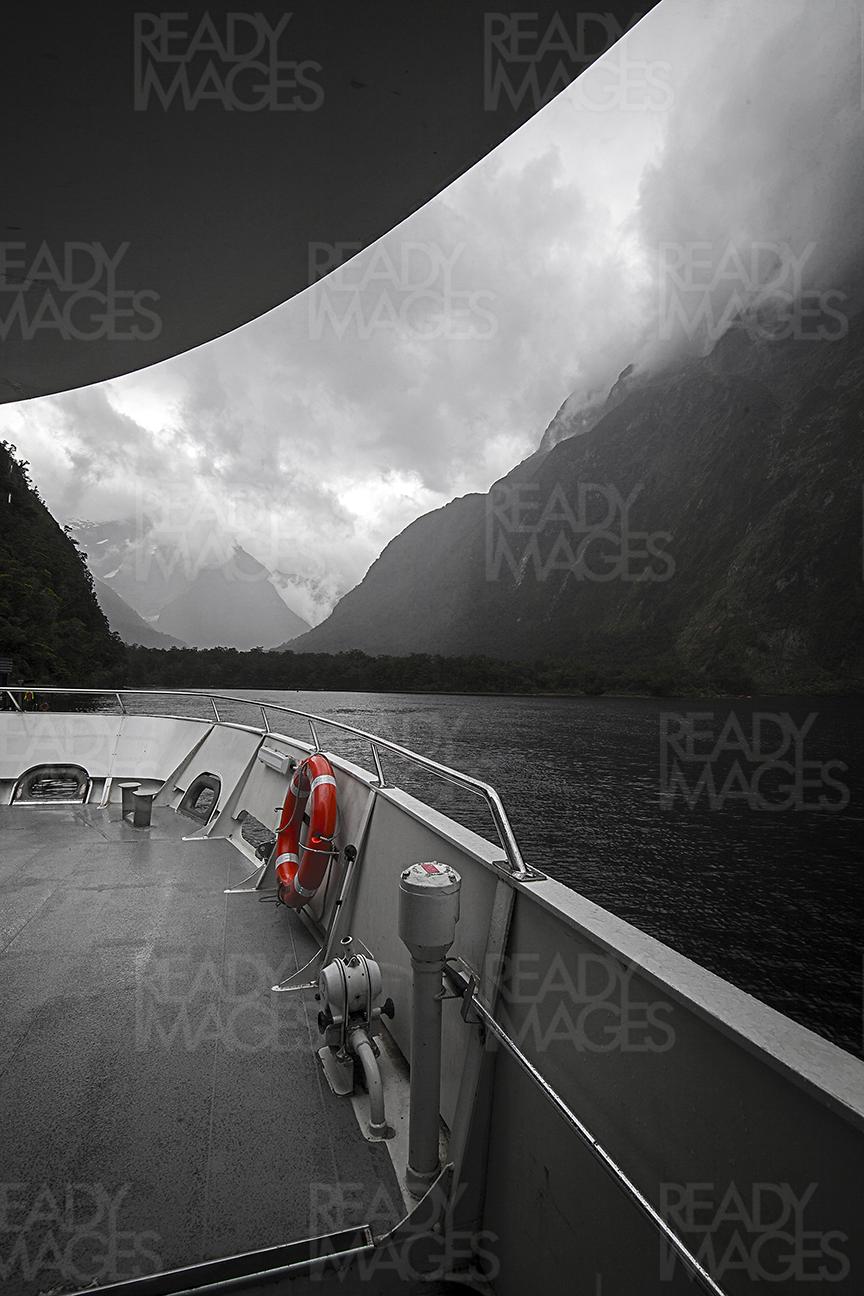 Image of Fiordland National Park Mountains from the boat, taken on dramatic and moody weather