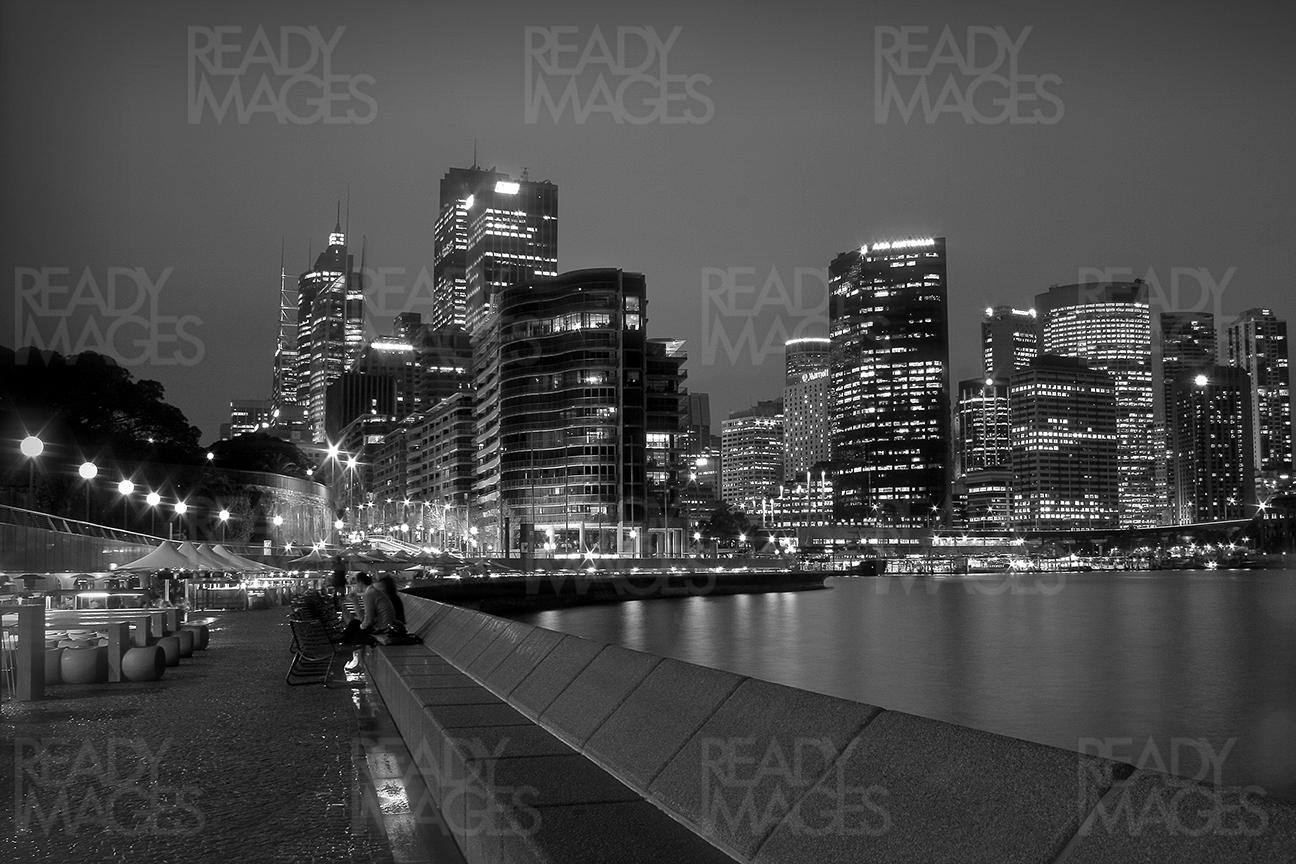 View of the city from Sydney Harbour near Opera House at night, using the long exposure technique