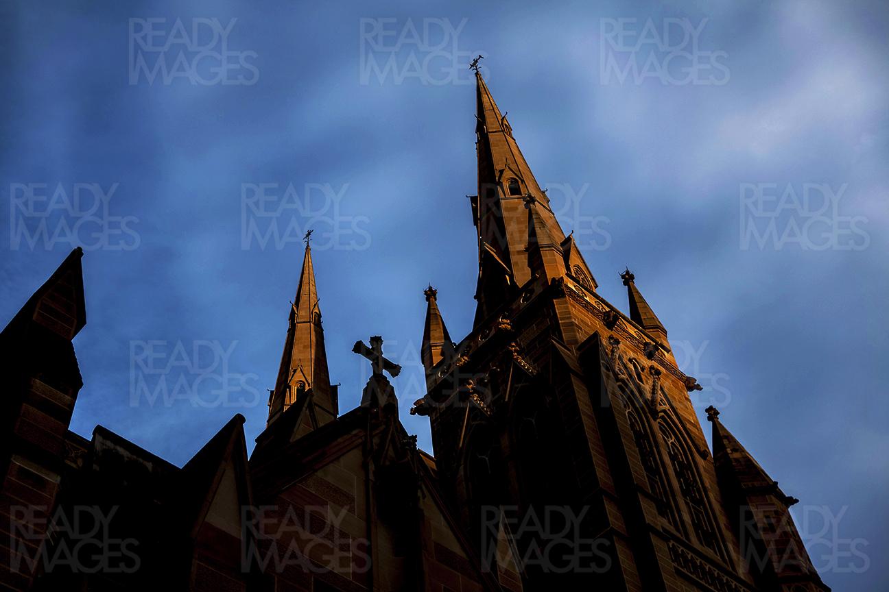 View from down, looking up at St Mary's Cathedral, a famous tourist spot in Sydney CBD located close to Hyde Park. Blue hour photography, also known as the magic hour photography
