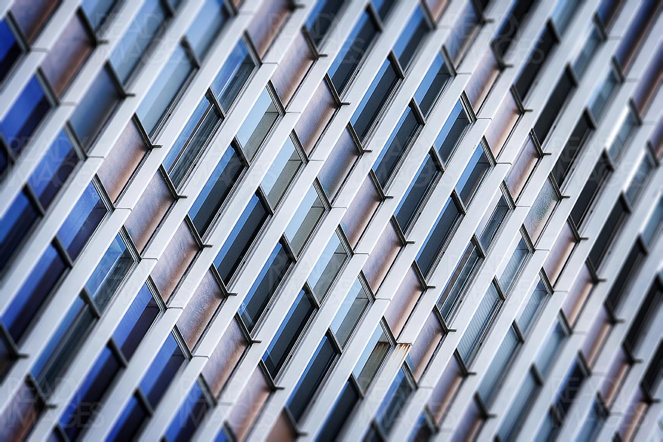 Abstract image of the facade of a commercial building in Sydney CBD. The blades shade the windows from harsh sunlight