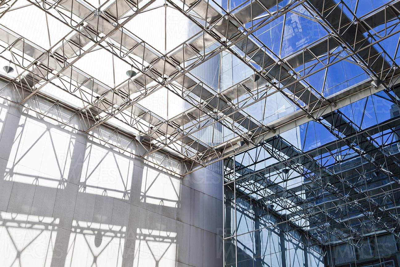 Image of a large awning of an atrium building, creating interesting shadows on a bright sunny day