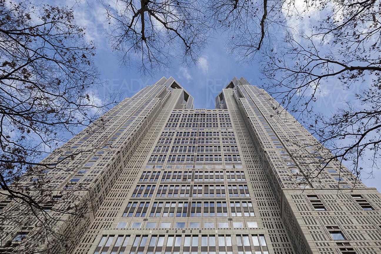 Looking up from the plaza of Tokyo Metropolitan Government Building designed by architect Kenzo Tange. The building is 43 stories tall and houses an observation deck on top giving beautiful views of Tokyo City. It is located very close to Shinjuku Station