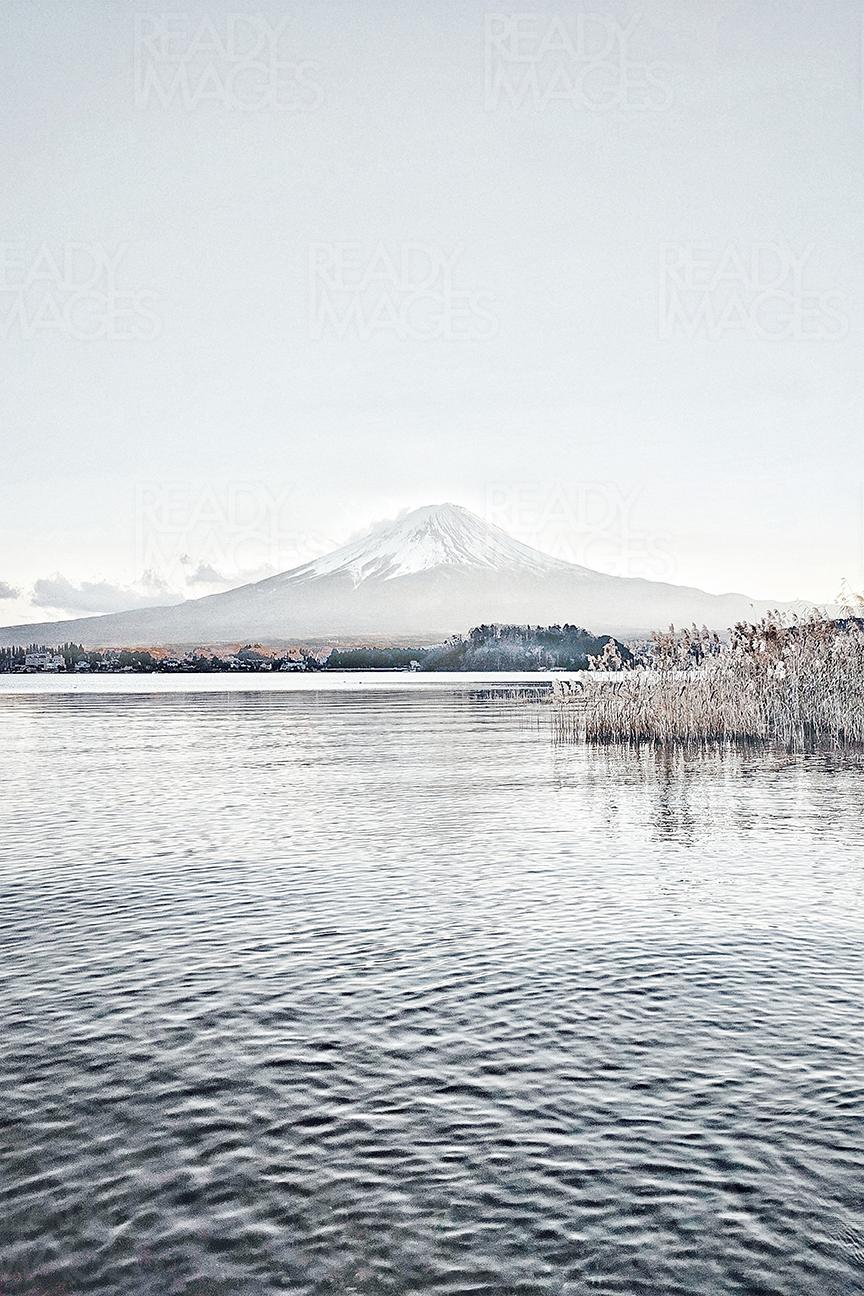 Vertical Image of snow-capped Mount Fuji from Lake Kawaguchiko, taken on a cold winter day