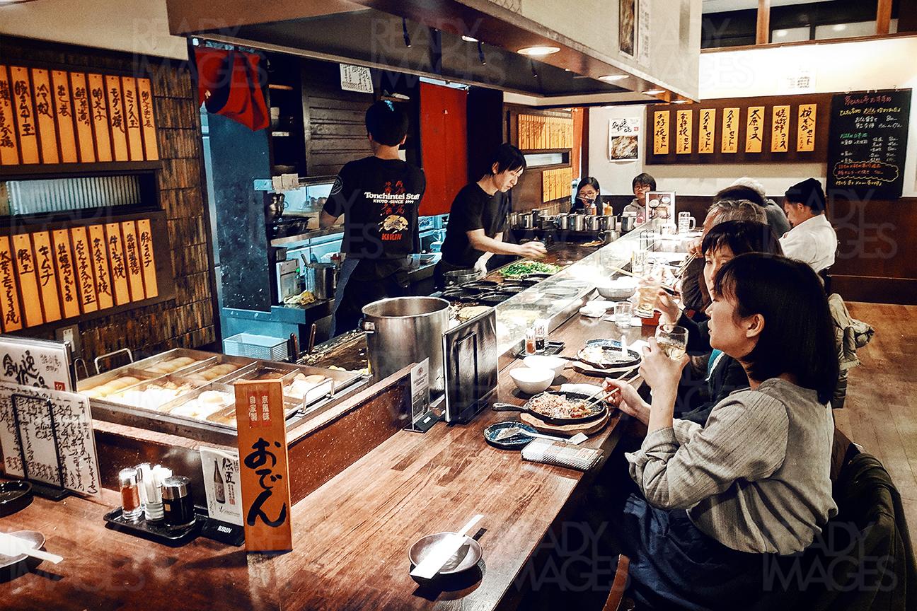 People eating food in one of the restaurants in Tokyo, Japan