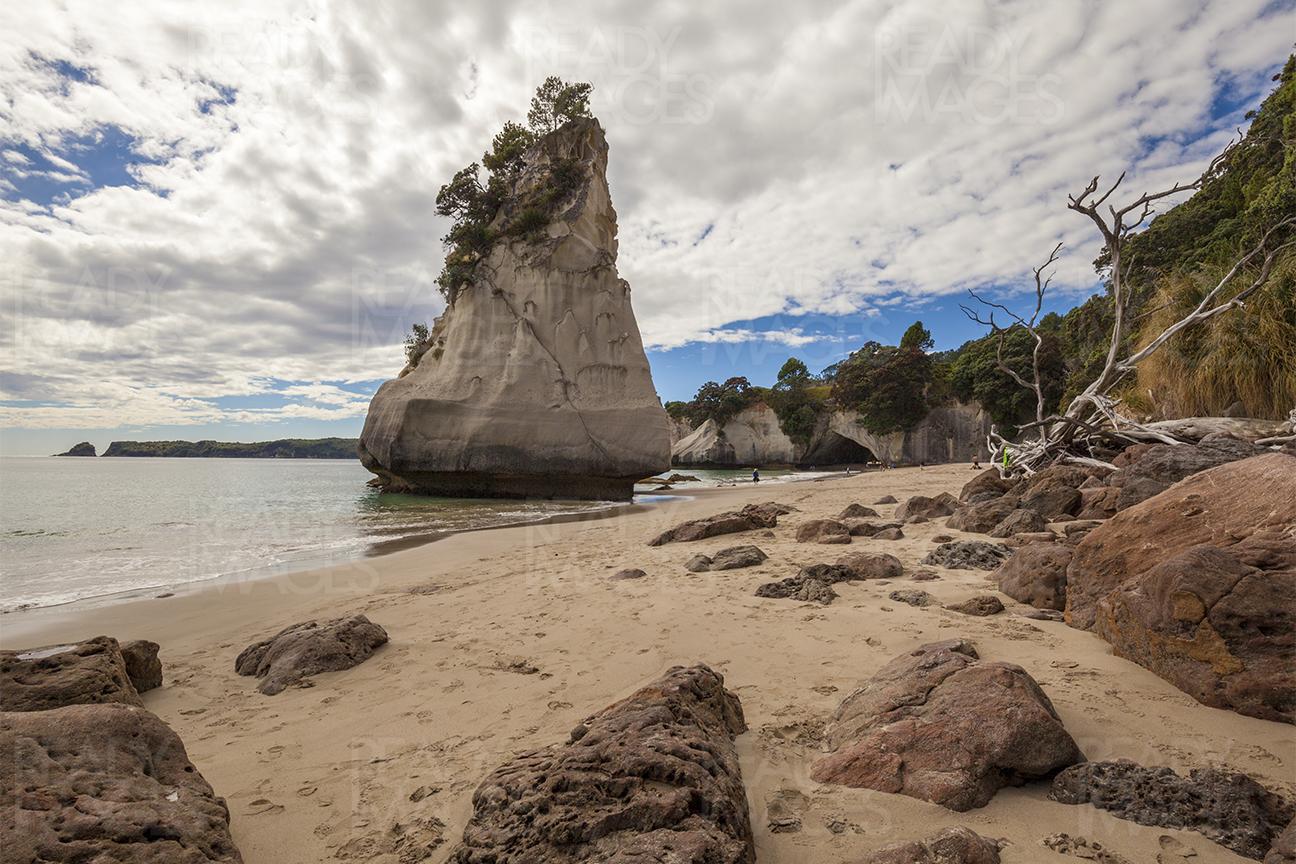 Clouds, rocks, cave and the beach at the Cathedral Cove, Coromandel, New Zealand